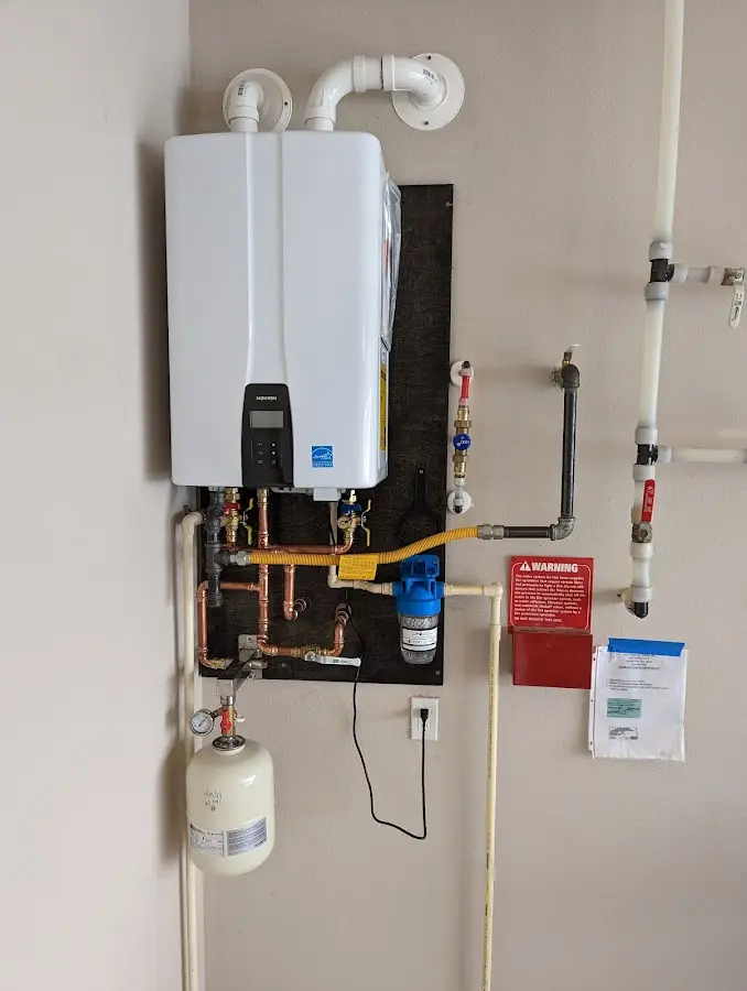 Professional plumber installing copper piping in a Denver home